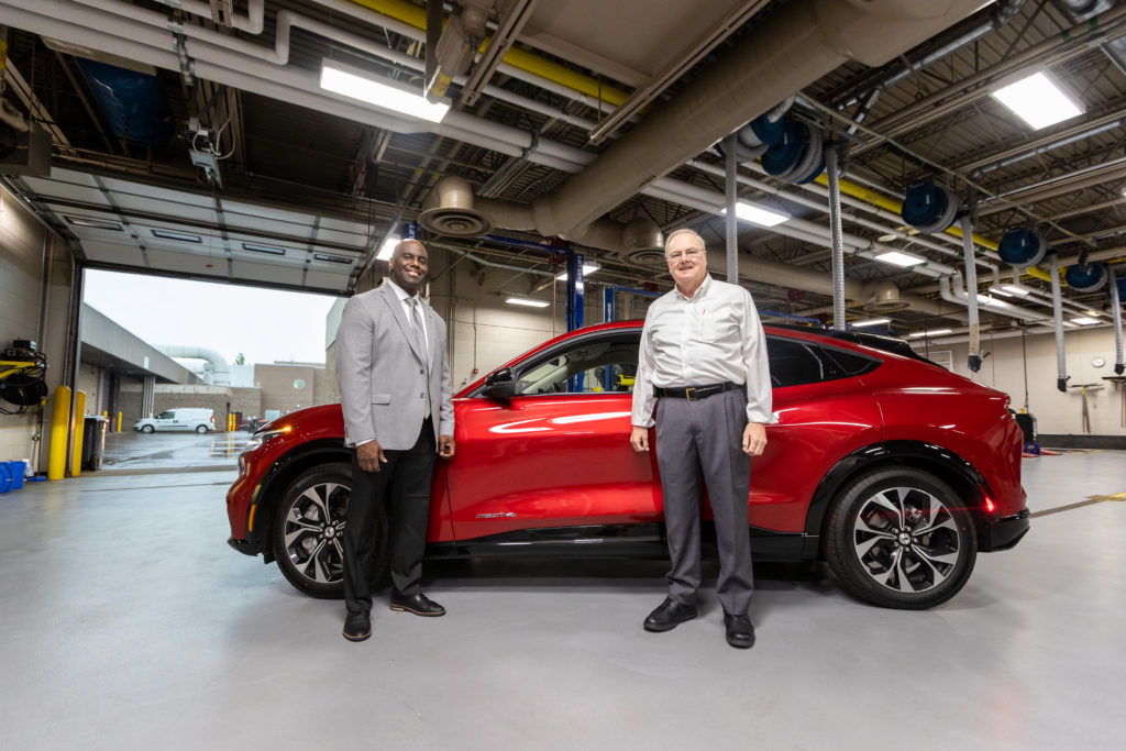 Image of Jimmie Baber and Al Lecz in front of the Ford Mustang Mach E at the Advanced Transportation Center