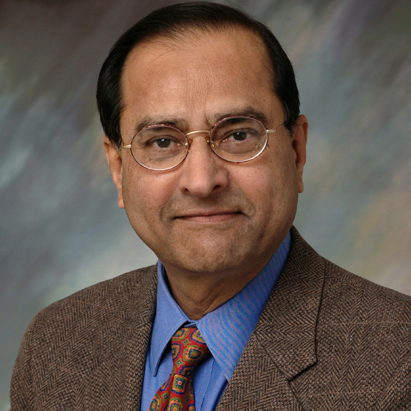 Headshot of Kumares Sinha. The link directs to their bio page.