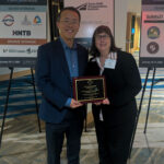 Henry Liu and Debby Bezzina holding the 2026 CUTC Technology Transfer Leadership Award