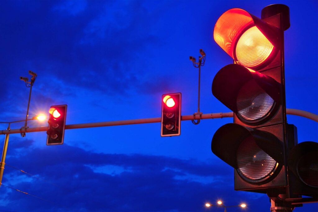 A set of traffic signals showing solid red