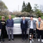 Ziran Wang LLM Team standing in front of a research vehicle