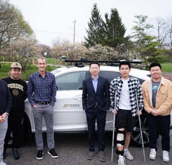 Ziran Wang LLM Team standing in front of a research vehicle